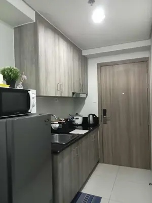 a kitchen with a refrigerator and a microwave at Free Wi-Fi Luxurious Haven by the Bay - 2BR Near MOA PICC CCP in Manila