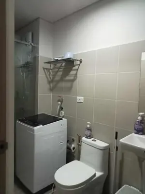 a small bathroom with a toilet and a sink at Free Wi-Fi Luxurious Haven by the Bay - 2BR Near MOA PICC CCP in Manila