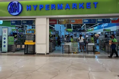 a supermarket with people standing at tables in a store at 5 minutes to Jazz Mall! Studio-type condo 100mbps in Manila