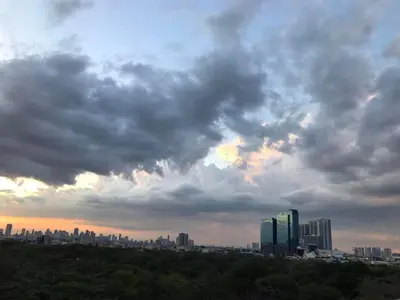 a city skyline under a cloudy sky with buildings at 5 minutes to Jazz Mall! Studio-type condo 100mbps in Manila