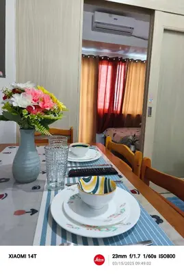 a dining room table with a vase of flowers on it at Condo UNIT-SM JAZZ RESIDENCES in Manila