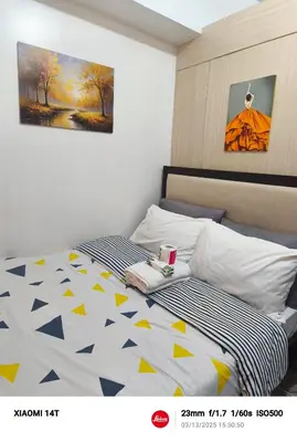 a bedroom with two beds and a painting on the wall at Condo UNIT-SM JAZZ RESIDENCES in Manila