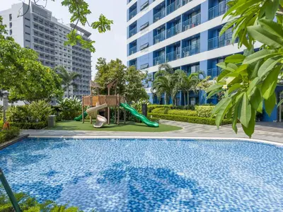 a swimming pool with a slide and a playground at GemstoneBR II@SMDC Air Residences in Manila