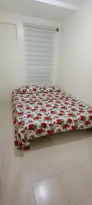 a bedroom with a bed with a red and white blanket at URBAN DECA Homes SM EAST Pasig in Manila
