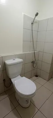a white toilet in a bathroom with a shower at URBAN DECA Homes SM EAST Pasig in Manila