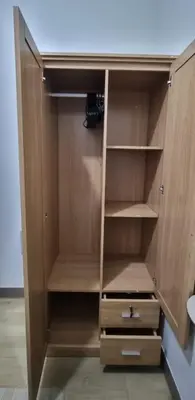 a wooden cupboard with shelves and a desk at Bicutan Urban Haven in Manila