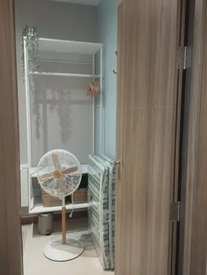 a room with a fan and a glass door at S Residences in Manila