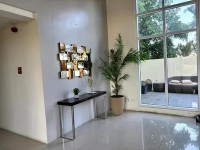 a living room with a table and a window at Casa Del Hasmin in Puting Kahoy