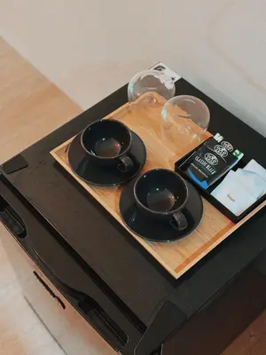 a wooden tray with three bowls on a table at Manila Staycation Rental in Manila