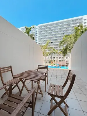a patio with a table and chairs and a building at Manila Staycation Rental in Manila