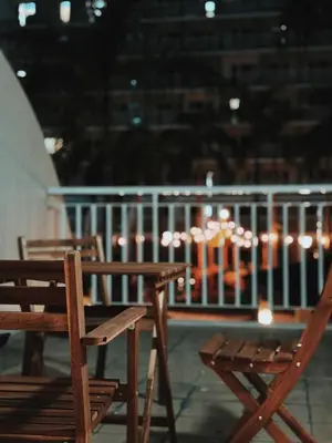 two wooden chairs and a table on a balcony at Manila Staycation Rental in Manila