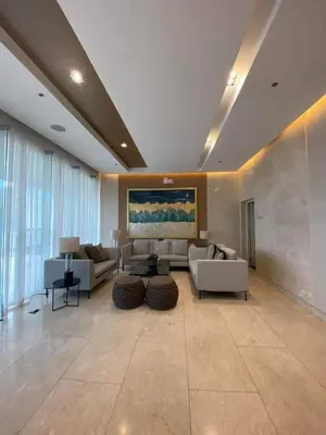 a large living room with couches and a painting on the wall at One bedroom with Balcony-M&M City Comfort in Manila