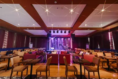 a banquet hall with tables and chairs and a stage at Monaco Hotel in Taytay