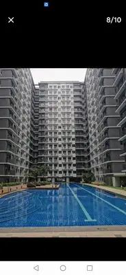 a large swimming pool in front of two large buildings at MOA Shore 3 tower 2 in Manila