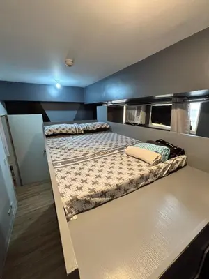 a bedroom with two beds in a room with blue walls at Holland Park Condominium in Jalang