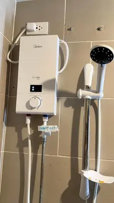 a room with a hair dryer and other devices on a wall at Holland Park Condominium in Jalang