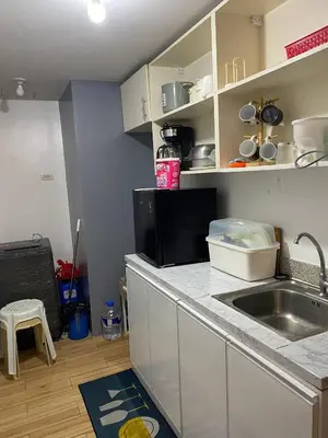 a kitchen with a sink and a counter top at Holland Park Condominium in Jalang