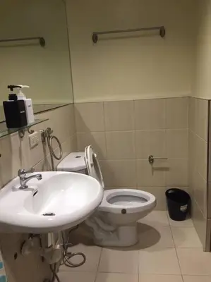 a bathroom with a sink and a toilet at Spacious Studio Apartment B302 in Manila