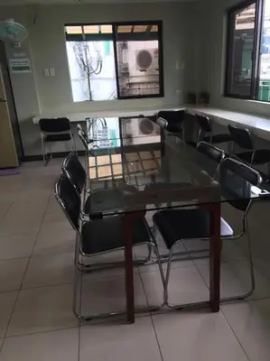 a glass table and chairs in a room at Spacious Studio Apartment B302 in Manila