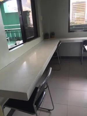 a long counter in a room with two chairs at Spacious Studio Apartment B302 in Manila