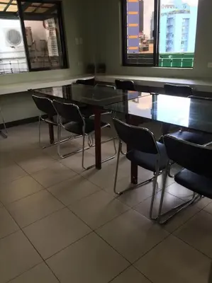 a row of tables and chairs in a room at Spacious Studio Apartment B302 in Manila
