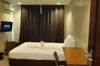 a bedroom with a bed with a sink and a window at Spacious Studio Apartment B304 in Manila
