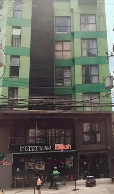 a tall green building with a sign on it at Spacious Studio Apartment B304 in Manila