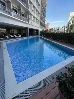 a large swimming pool in the middle of a building at House KubU at Lush Residences Makati in Manila