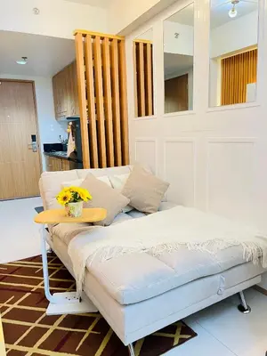 a bed in a room with a table on it at Amazing Condo Unit Shore 3 - walking distance to MOA - Pasay - 2 Beds - with 1 extra bed in Manila