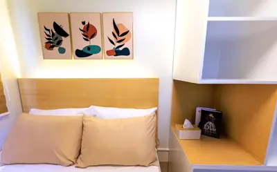 a bed with a wooden headboard with three pictures above it at Amazing Condo Unit Shore 3 - walking distance to MOA - Pasay - 2 Beds - with 1 extra bed in Manila