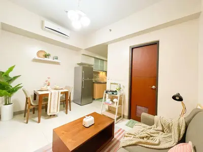 a living room with a couch and a table at BGC's Best Condo Near Uptown Mall #oursw15o in Manila