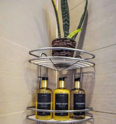 a shelf with four bottles of oils on a wall at New Modern Luxurious 2Bedroom in Eastwood in Manila