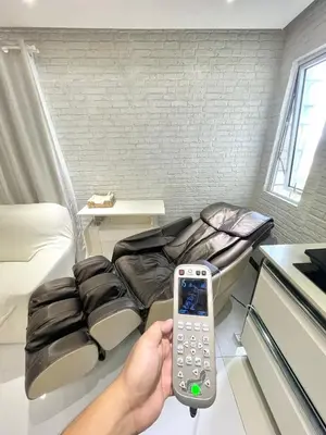 a person holding a remote control in a room at Thompson Suites Fort Victoria Tower BGC Loft Type 1BR in Manila