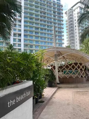 a beach belt sign in front of a large building at The Solaris Point with Pool View in Manila