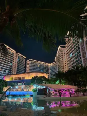 a view of a hotel at night with buildings at The Solaris Point with Pool View in Manila