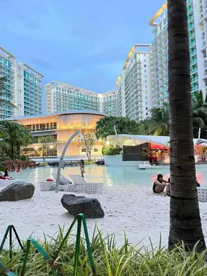 a swimming pool in front of a large building at The Solaris Point with Pool View in Manila