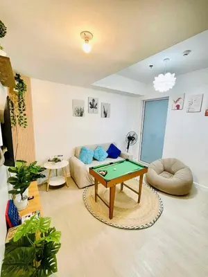 a living room with a ping pong table in it at The Solaris Point with Pool View in Manila