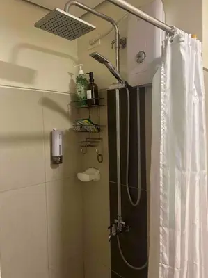 a bathroom with a shower with a shower curtain at Condo with Bayview in Manila (along Roxas Boulevard) in Manila