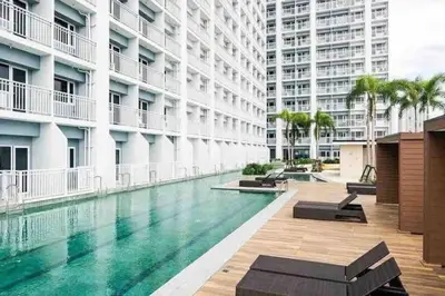 a swimming pool in the middle of a building at Condo with Bayview in Manila (along Roxas Boulevard) in Manila