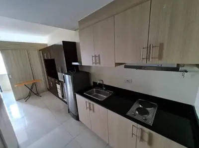 a kitchen with a sink and a refrigerator at Condo with Bayview in Manila (along Roxas Boulevard) in Manila