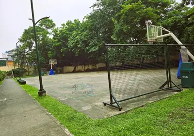 an empty basketball court with a basketball hoop at Cozy 2BR Staycation with Balcony Chateau Elysee for 4-6 Pax in Manila