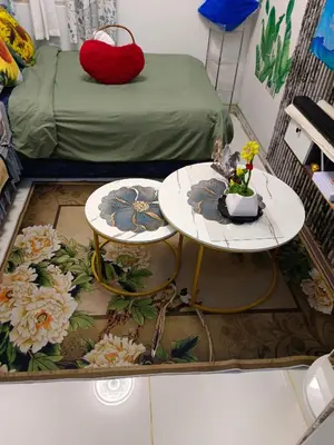 a room with two tables with flowers on the floor at Caine's Cabin 27th Feel our Love and Warmth Welcome in Manila