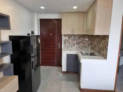 a kitchen with a sink and a black refrigerator at C Mary's Staycation in Tanza Cavite Condo Type with balcony good for 2 person in Tanza