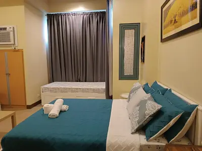 a bedroom with a bed with towels on it at Rj Condotel Near Naia Terminal 3 in Manila