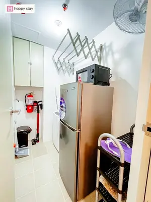 a kitchen with a refrigerator and a tv on top of it at Happy Stay in Manila