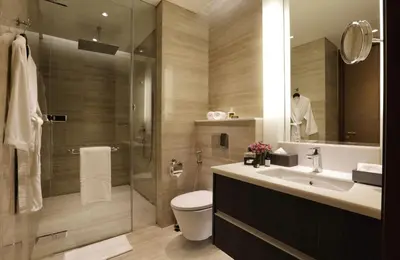 a bathroom with a toilet and a sink and a shower at Makati Diamond Residences in Manila