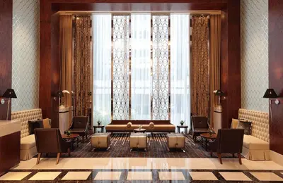 a lobby with a couch and a large window at Makati Diamond Residences in Manila