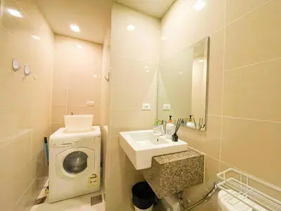 a bathroom with a sink and a washing machine at Best BGC Condo Near Uptown Area #oursw30b2 in Manila