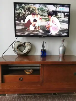 a flat screen tv sitting on top of a wooden entertainment center at Shore 3 mall of Asia condotel in Manila