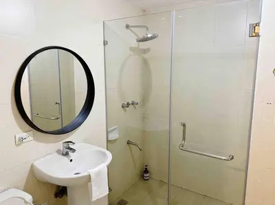 a bathroom with a sink and a shower with a mirror at Gora studio in Avant BGC parking with fee in Manila